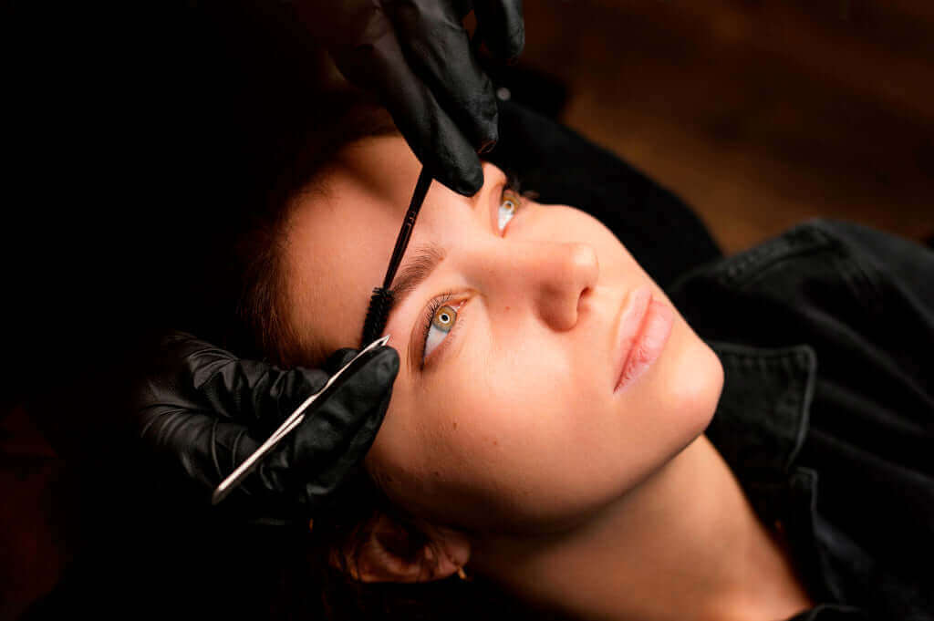 Estheticienne professionnelle réalisant un soin du visage en institut